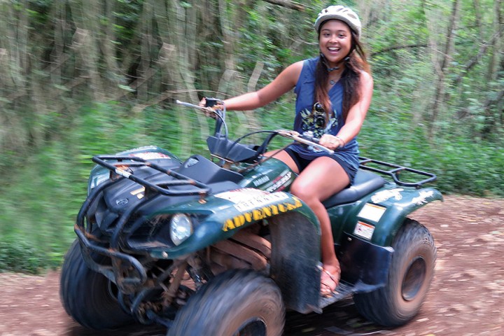 A girl riding her ATV